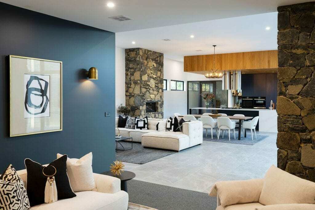 Homes by Howe, knock down rebuild, Deakin, open plan living area looking out onto courtyard pool, drystone wall fireplace