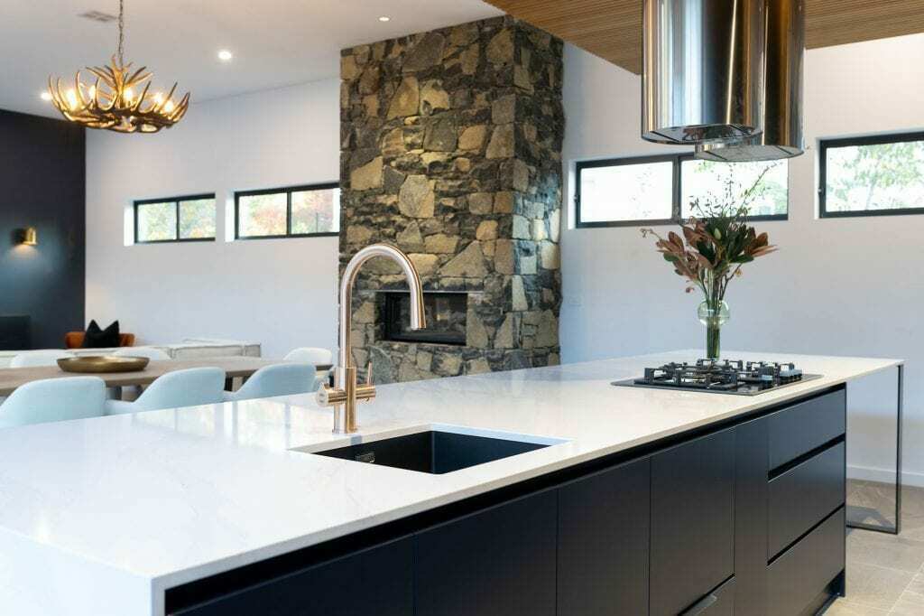 Homes by Howe, knock down rebuild, Deakin, kitchen, navy blue cabinetry with white talostone benchtops and gold facets, large central island with slatted wood detailing on ceiling above