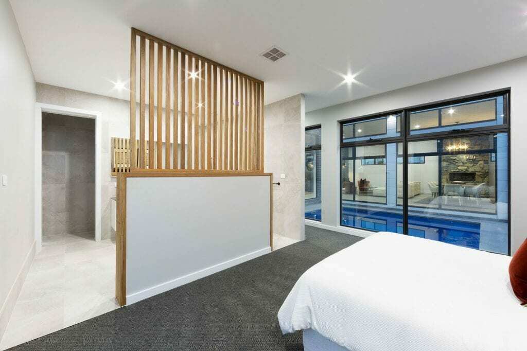 Homes by Howe, knock down rebuild, Deakin, master bedroom with attached ensuite and view out onto courtyard pool, large floor to ceiling windows