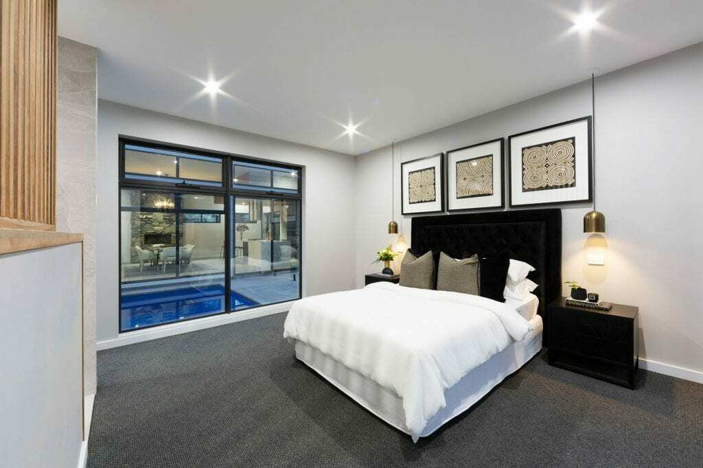 Homes by Howe, knock down rebuild, Deakin, master bedroom with attached ensuite and view out onto courtyard pool, large floor to ceiling windows