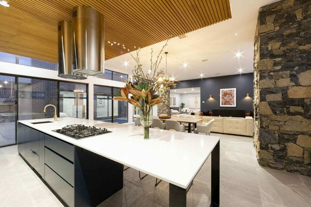 Homes by Howe, knock down rebuild, Deakin, kitchen, navy blue cabinetry with white talostone benchtops and gold facets, large central island with slatted wood detailing on ceiling above