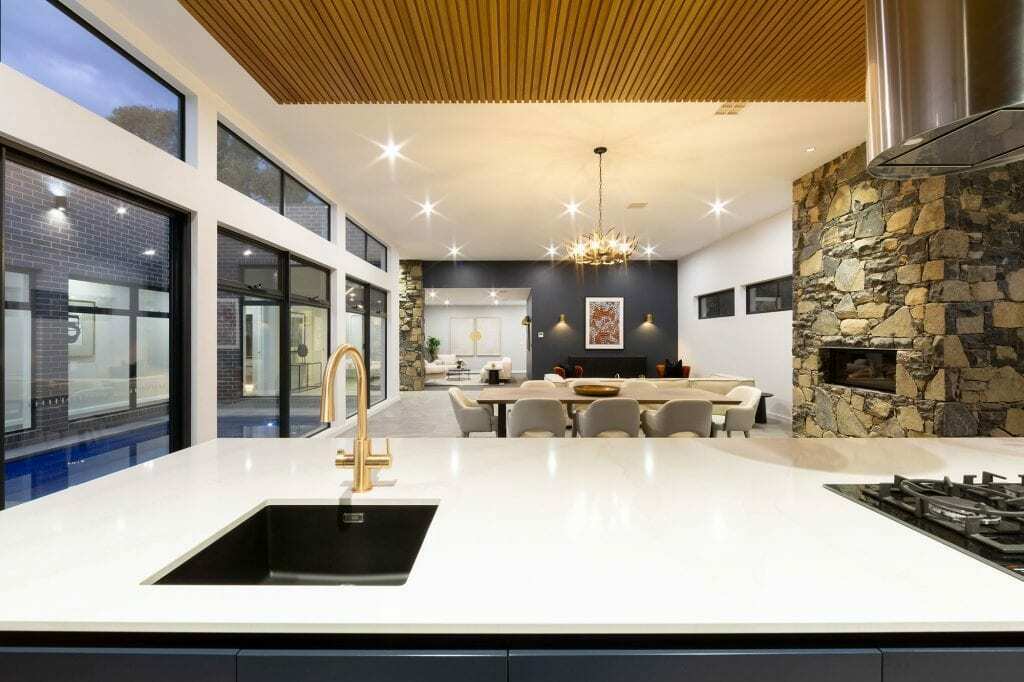 Homes by Howe, knock down rebuild, Deakin, kitchen, navy blue cabinetry with white talostone benchtops and gold facets, large central island with slatted wood detailing on ceiling above