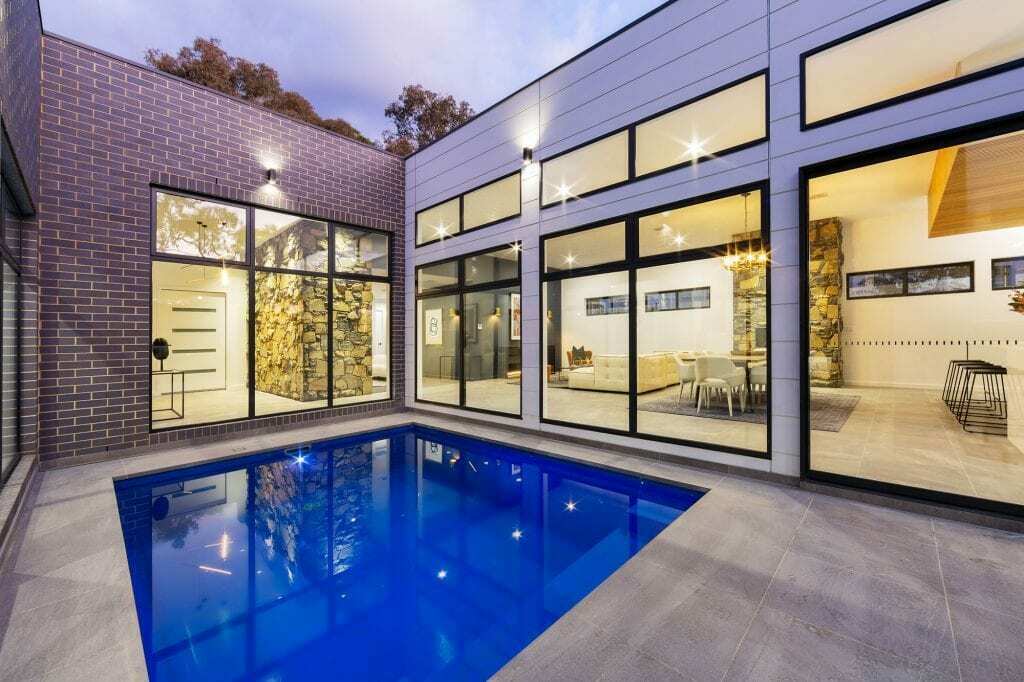 Homes by Howe, knock down rebuild, Deakin, courtyard pool, windows look in to open plan living area