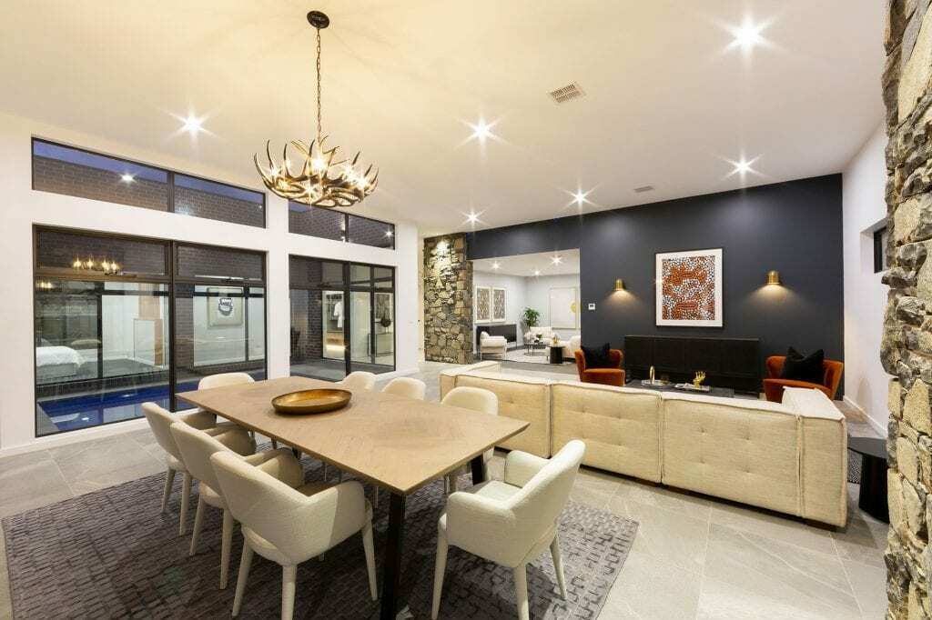 Homes by Howe, knock down rebuild, Deakin, open plan living area looking out onto courtyard pool, drystone wall fireplace