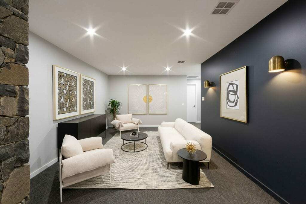 Homes by Howe, knock down rebuild, Deakin, open plan living area looking out onto courtyard pool, drystone wall fireplace