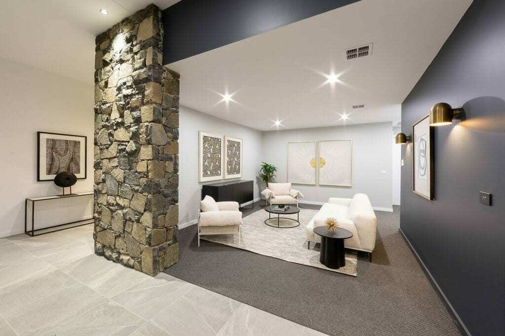 Homes by Howe, knock down rebuild, Deakin, open plan living area looking out onto courtyard pool, drystone wall fireplace