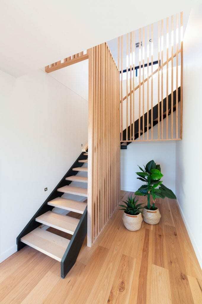 Homes by Howe, new build, Denman, staircase, light wooden slatting instead of railing, decorative plants at base