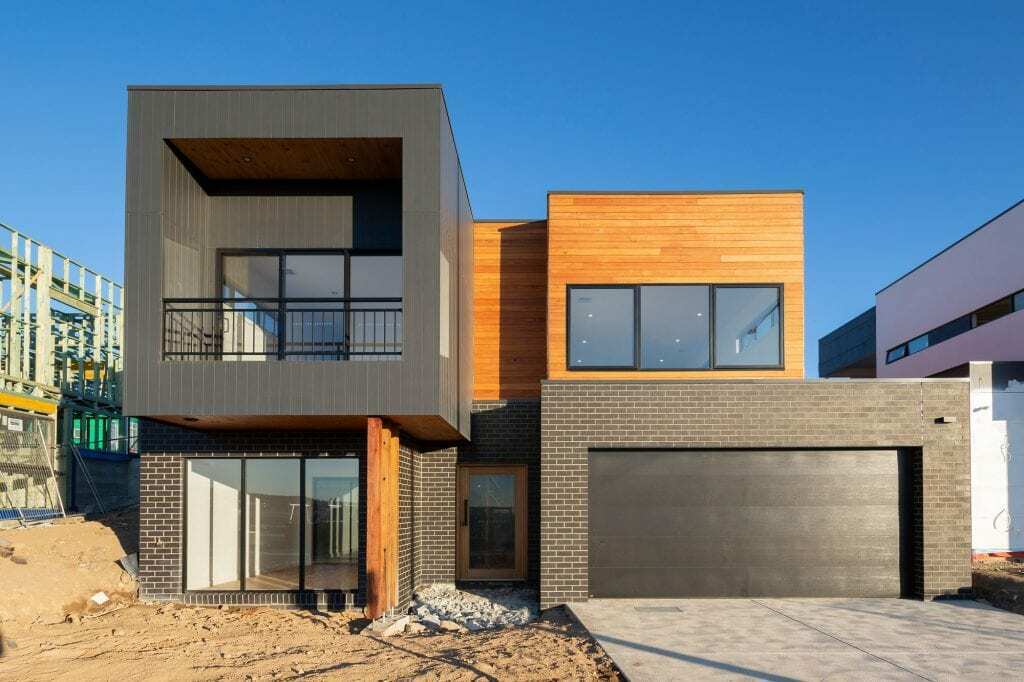 Homes by Howe, new build, Denman, exterior, numerous rectangular volumes stacked on top of one another, some brick, some glass facing