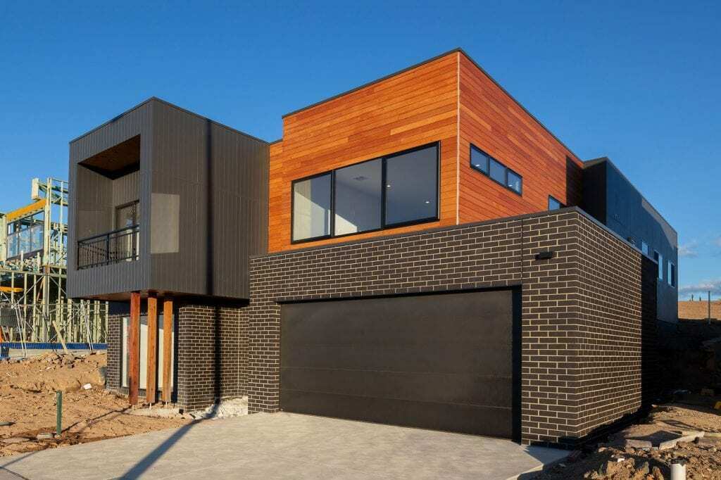 Homes by Howe, new build, Denman, exterior, numerous rectangular volumes stacked on top of one another, some brick, some glass facing