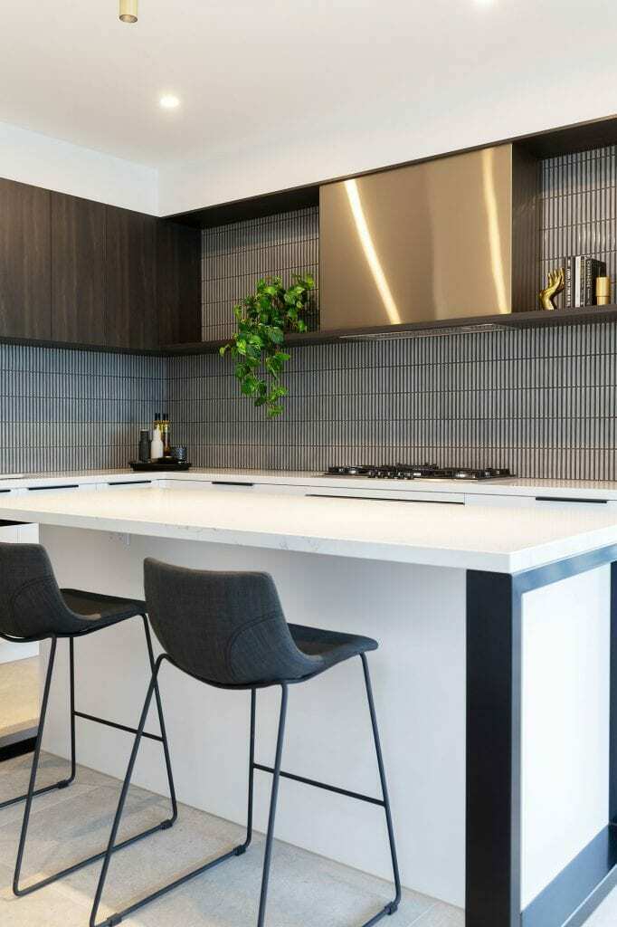 Homes by Howe, knock down rebuild, Red Hill, kitchen, white island, blue vertical tiling splashback, brown ceiling cabinetry
