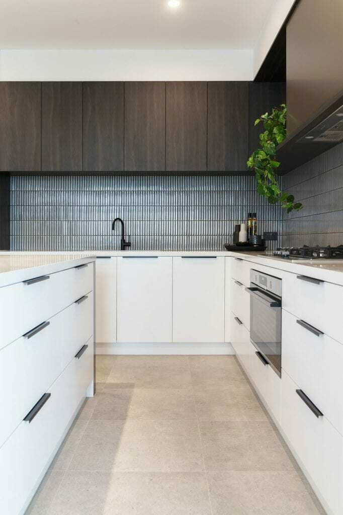 Homes by Howe, knock down rebuild, Red Hill, kitchen, white low cabinetry, tile flooring, blue tile spalshback, in built oven and hob