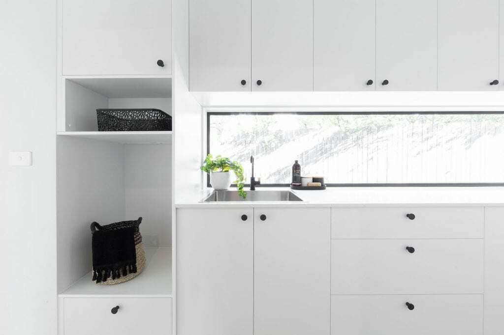 Homes by Howe, knock down rebuild, Red Hill, laundry, floor to ceiling white cabinetry with inbuilt sink and low, long window