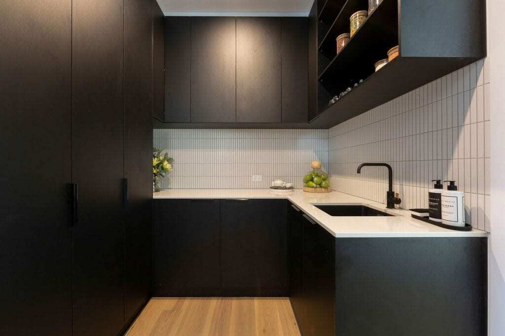 Homes by Howe, knock down rebuild, Red Hill, Kitchen pantry, black floor to ceiling cabinets, white marble sink, black sink and tap, white tiling vertical splashback