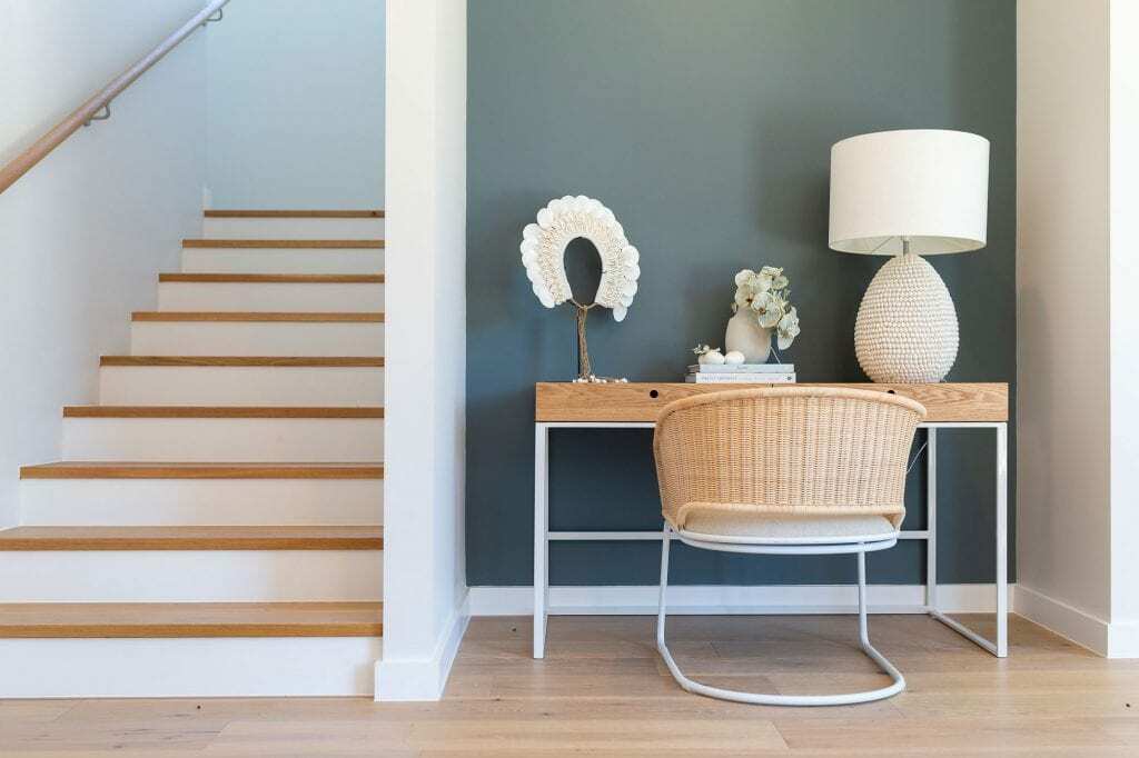 Homes by Howe, knock down rebuild, Red Hill, entrance hall with chair and desk, teal feature wall