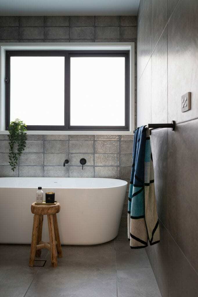 Homes by Howe, new build, Throsby, bathroom, freestanding bath below window and grey tiling