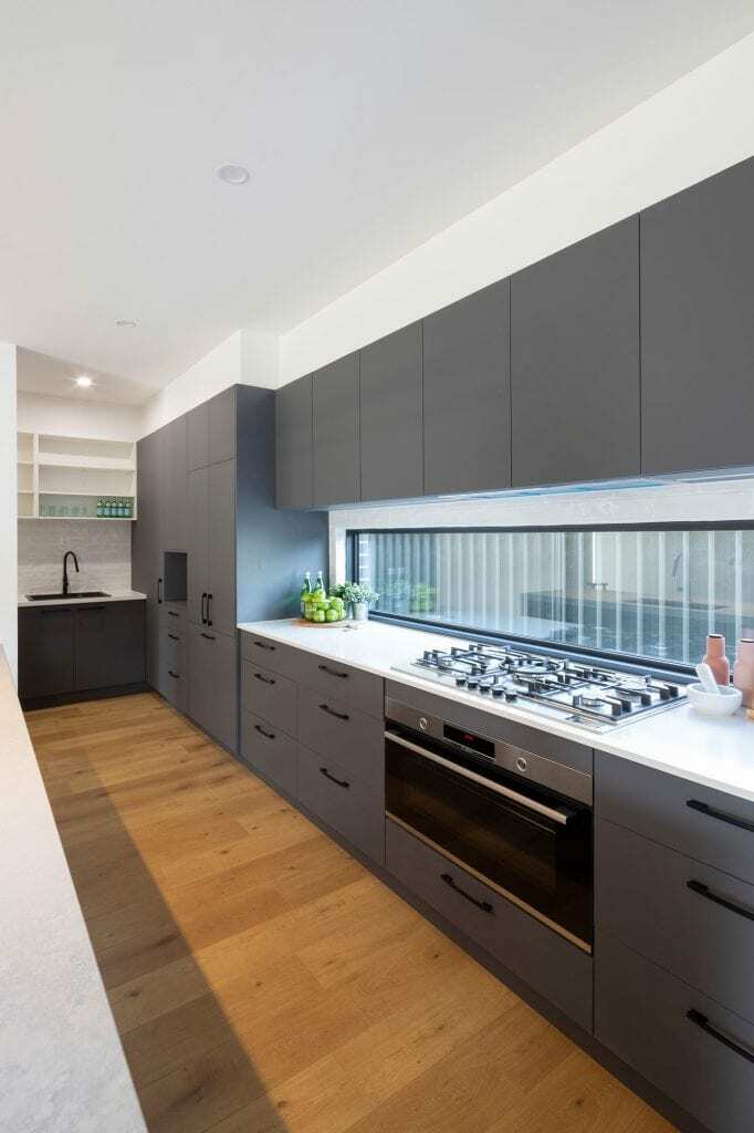 Homes by Howe, new build, Throsby, kitchen, floor to window grey cabinetry, narrow window behind gas hob