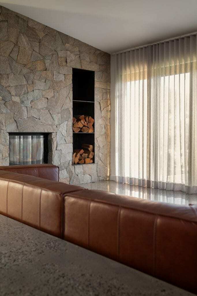 Homes by Howe, new build, Burra, sunken living room, dry stone walling around fireplace, large leather couch and polished concrete floors