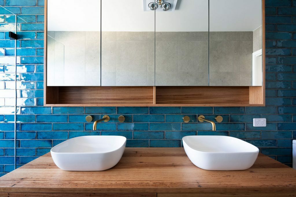 Homes by Howe, knock down rebuild, Duffy, bathroom, close up of dual vanities, mirrored storage cupboards above, turquoise tiling splashback