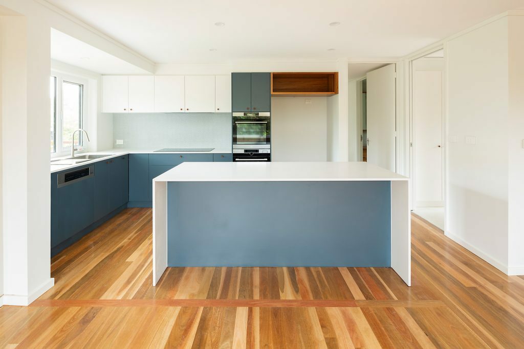 Homes by Howe, renovation, Cook, kitchen, kitchen island with blue highlights and cabinetry, dual ovens