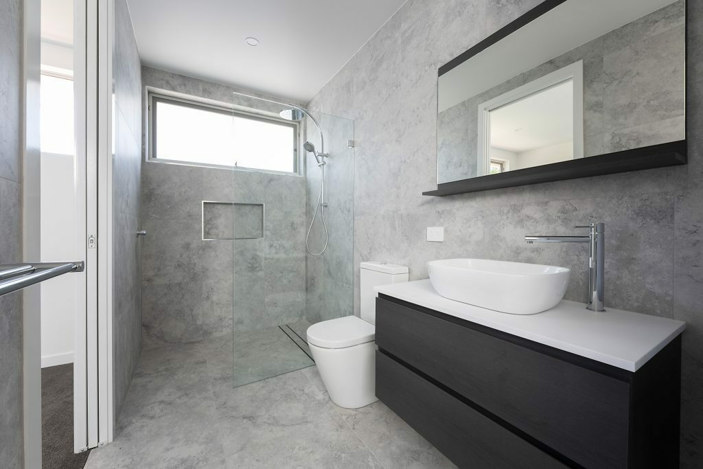 Homes by Howe, Canberra builder, dual occupancy, knock down rebuild, O'Connor, bathroom, dual sink vanity, grey floor to ceiling tiling, large shower and slot window