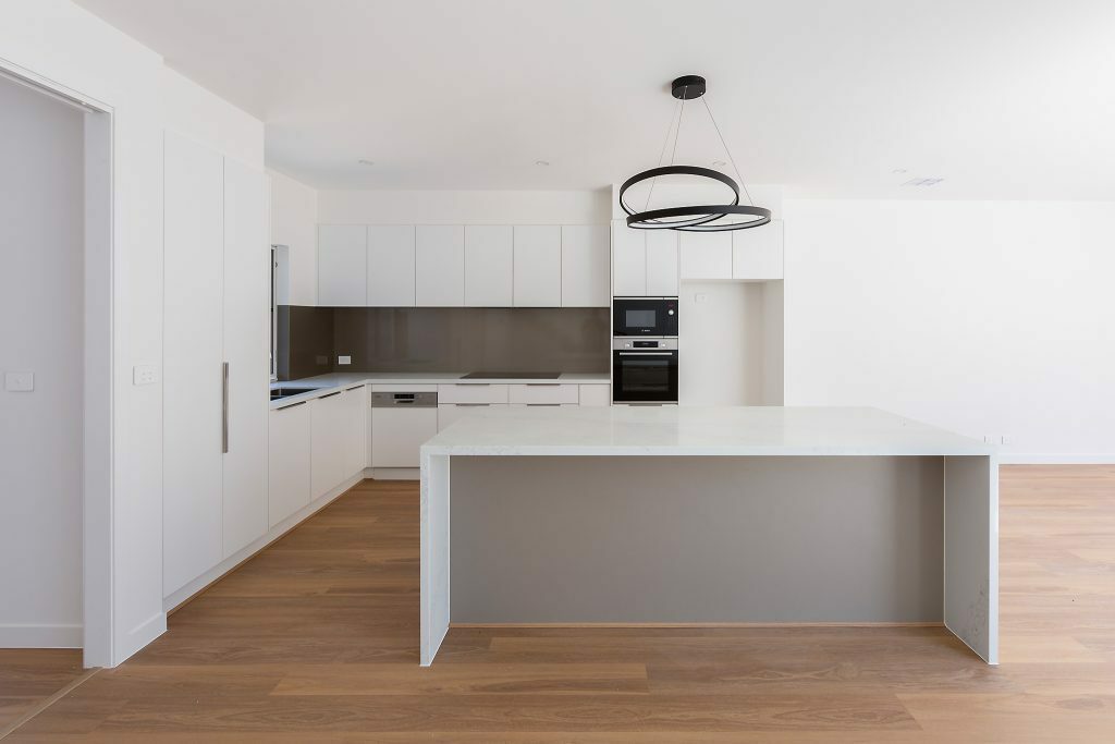 Homes by Howe, Canberra builder, dual occupancy, knock down rebuild, O'Connor, kitchen and open plan living view, spine-back staircase, floor boards and large floor to ceiling windows